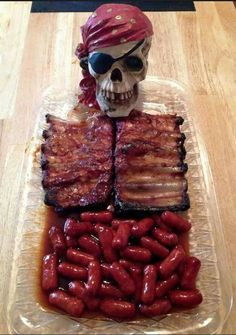 a skull sitting on top of a table next to bacon