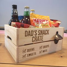 a wooden crate filled with beer and snacks