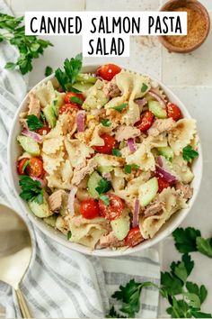 a white bowl filled with pasta salad on top of a table