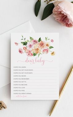 an advice card with pink flowers and greenery on it next to a gold pen