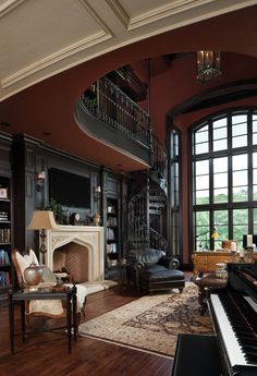 a living room filled with furniture and a piano in front of a fire place on a hard wood floor