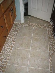 the bathroom floor is made up of giraffe print tile and wood cabinetry