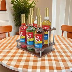 four bottles of alcohol are sitting on a table with a checkered cloth covered tablecloth