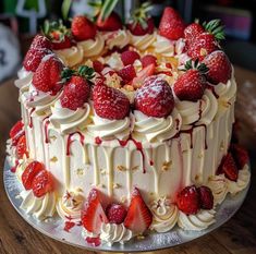 a cake with white frosting and strawberries on top