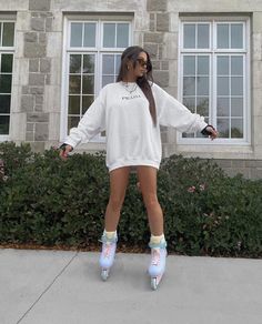 a woman wearing roller skates standing in front of a building