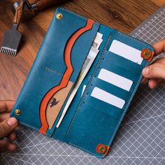 a person holding an open wallet with toothbrushes in it on top of a table