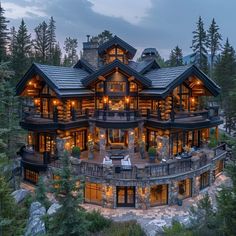 a large house with lots of windows and lights on it's roof, surrounded by trees