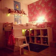 a child's room with a bunk bed, desk and toy chair in it