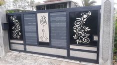 a black and white gate with designs on it