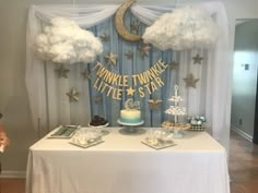 a table topped with cakes and desserts under clouds