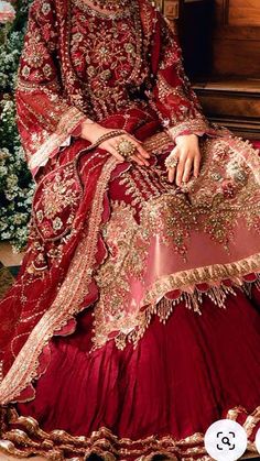 a woman in a red and gold wedding dress