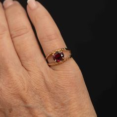 Specifications: Metal: 14k Gold (Tested) Ring Size: 6 (US) Weight: 4.5 grams Stone: Garnet Stone Cut: Oval Stone Size: 8mm x 6mm Setting: Basket split shank with 4 prongs Design: 6 leaf-type designs on the shank Introducing a stunning 14k gold ring featuring a large oval garnet set in a unique basket split shank setting. The garnet, measuring 8mm x 6mm, is held securely by four prongs and placed sideways for a distinctive look. The setting is adorned with six leaf-type designs on the outside of Classic Oval Ruby Ring With Diamond Cut, Heirloom Oval Ruby Ring With Diamond Cut, Gold Ruby Ring, Oval Diamond Cut, Oval Birthstone Signet Ring For Anniversary, Heirloom Oval Diamond Cut Birthstone Ring, Anniversary Oval Birthstone Signet Ring, Oval Hallmarked Birthstone Ring For Anniversary, Oval Ruby Ring Stamped 14k For Anniversary, Oval Ruby Ring For Anniversary Stamped 14k