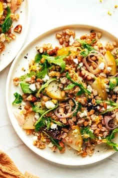 two white plates filled with food on top of a table