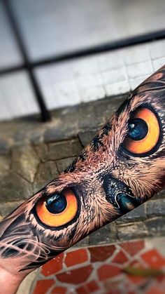 an owl's eye is shown on the arm and it appears to be painted