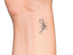 a small tattoo on the wrist of a woman