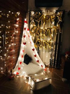 a teepee tent decorated with hearts and lights for a birthday party or anniversary celebration