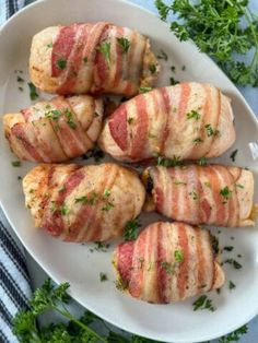 bacon wrapped chicken on a plate with parsley