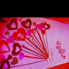 there are many hearts on the wall with words all you need is valentine's day