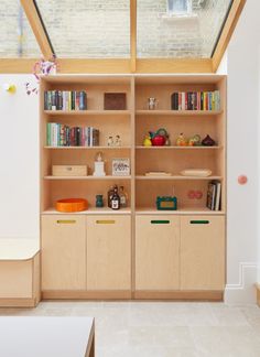 the bookshelf has many different types of books on it and is made out of plywood