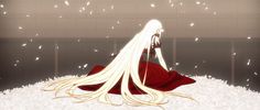 a woman with long white hair sitting in the snow