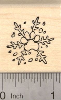 a rubber stamp with an image of a snowflake on it and a ruler