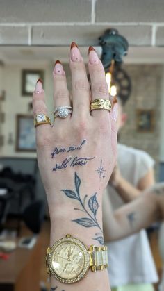 a woman's hand with tattoos and two gold rings on her left wrist that says, i love you all the time