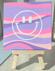 an easel with a painted smiley face on it