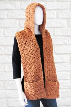 a mannequin wearing a brown crocheted scarf