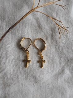 "Delicate pair of earrings with tiny golden crosses. Possibility of replacing the \"sleepers\" loops fasteners with \"French hook\" style on simple request. ------------------------ Earrings with sleepers hooks in gold-plated stainless steel. Mini budded Latin crosses in gold-tone stainless steel with a slightly shiny finish. This is yellow gold color steel: the dark areas in the photos are just shadows, the earrings are not black. Dimensions: \"Sleeper\" hooks loops: about 1 cm in diameter Cros Dark Academia Jewelry, Gothic Earrings, Cross Earrings, Gold Cross, Dark Academia, Matching Necklaces, Minimalist Earrings, Jewelry Earrings Hoops, Boho Earrings