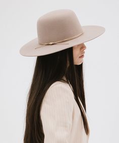 Rue is a sophisticated, classic open crown shape with a structured semi-wide brim. This is the only hat featuring hand-stitched detailing on the brim's edge for a subtle, distinctive touch. Included is a tonal triple-strand waxed leather band that is both adjustable + removable for styling. Elegant Beige Fedora With Flat Crown, Classic Spring Felt Hat For Rodeo, Elegant Fitted Hat With Flat Crown, Elegant Beige Hat With Flat Crown, Classic Unlined Flat Brim Fedora, Classic Wide Brim Top Hat For Spring, Elegant Spring Top Hat With Flat Crown, Elegant Short Brim Boater Hat For Rodeo, Elegant Brimmed Boater Hat For Rodeo