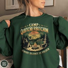 Welcome to Camp Quitcherbitchin! Where silence is golden and indeed preferred! This funny camping sweatshirt is the perfect gift for that camping or hiking lover in your life. The Gildan 18000 50/50 blend fabric has that comfy, lived-in feel, that's like a hug every time you put it on! Now you can celebrate the outdoors with a bit of humor wherever you wander! Grab one while you can, and hit the trail! * Product Highlights * Ideal for any situation, this Gildan 18000 heavy blend crewneck sweatsh Fall Camping Crew Neck Sweatshirt, Fall Crew Neck Sweatshirt For Camping, Outdoor Crew Neck Sweatshirt With Letter Print, Outdoor Letter Print Sweatshirt Crew Neck, Crew Neck Sweatshirt For Fall Camping, Letter Print Sweatshirt For Fall Camping, Crew Neck Sweatshirt For Camping, Fall Camping T-shirt With Letter Print, Outdoor Long Sleeve Sweatshirt With Screen Print