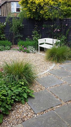 a white bench sitting in the middle of a garden