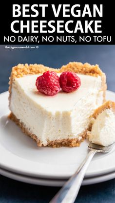 a white plate topped with a cheesecake covered in whipped cream and raspberries