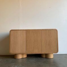 the sideboard is made out of wood and has three sections on each side, one with