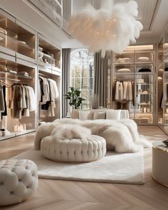 a large white bed sitting inside of a bedroom next to a walk in closet filled with clothes