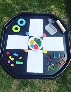 a child's play tray with letters and shapes on it