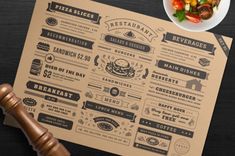 a restaurant menu on top of a wooden table next to a plate of food and a judge's gavel