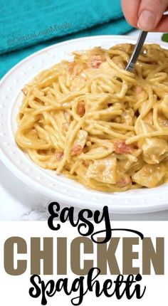 a person is cutting up some noodles on a white plate with the words easy chicken spaghetti