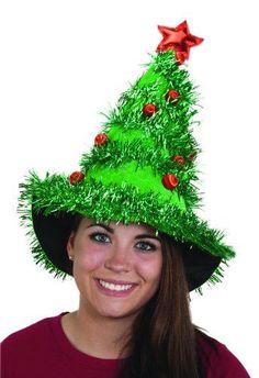 a woman wearing a green christmas tree hat