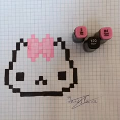 two markers are next to each other on a piece of paper with an image of a hello kitty