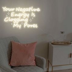 a neon sign that says your negative energy is logging my pores on the wall