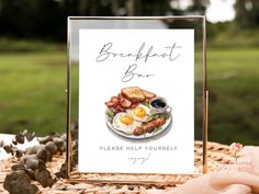 a sign that says breakfast bar on top of a plate with eggs and sausages