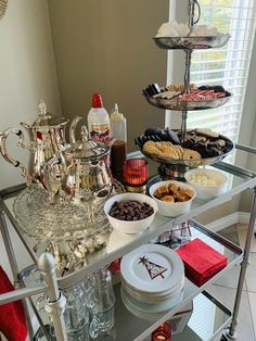 a silver serving cart filled with lots of food