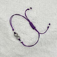 Subtle BTS inspired Apobangpo purple promise  bracelet with infinity charm.   Made of Korean waxed thread, it is waterproof, durable, and wearable 24/7.   Accented with clear silver lined Miyuki glass beads.  A reminder of BTS and ARMY's connection until the comeback in 2025.   Infinity charm is nickel, cadmium and lead free.   This bracelet fits wrists up to 9 inches around.  The length is adjustable with a sliding knot.  Pull both beaded ends to shorten length, and slide the knot away from you Casual Silver Hypoallergenic Friendship Bracelets, Casual Purple Hypoallergenic Jewelry, Purple Friendship Bracelet With Sliding Knot As Gift, Casual Silver Infinity Jewelry, Casual Purple Braided Bracelet As Gift, Adjustable Purple Sterling Silver Bracelet, Hypoallergenic Purple Friendship Bracelets, Purple Bracelets With Adjustable Cord, Adjustable Purple Bracelet With Cord