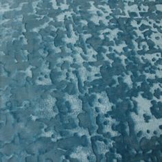 an area rug with blue and white designs on the ground, including small dots in the middle