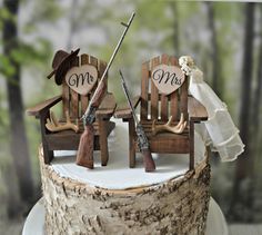 two wooden chairs sitting on top of a white cake covered in frosting and decorations