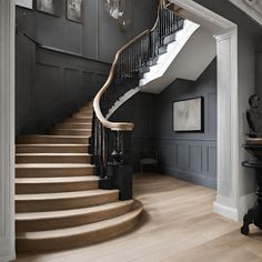 an elegant staircase with wooden steps and chandelier