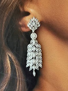 The SADIE statement earrings feature an exotic and unique look that can be worn for any occasion. The design gives it a 3D look to make the earrings refined and enduring. These will surely be the go to earrings in your high style collection and big event! Handcrafted Highest Quality Swarovski / Cubic Zirconia Platinum plated Guards against scratches and tarnish. approximate size 2.5" length 1" width Nickel free Free Shipping in USA Silver Drop Earrings For Glamorous Events, Luxury Silver Chandelier Earrings For Party, Luxury Dangle Clip-on Earrings For Party, Glamorous Single Earring For Formal Occasions, Elegant Chandelier Earrings, Glamorous Dangle Bridal Earrings For Glamorous Events, Elegant Dangle Chandelier Earrings For Glamorous Events, Luxury Crystal Drop Earrings For Party, Glamorous Evening Drop Cluster Earrings