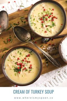 three bowls filled with soup on top of a wooden cutting board next to spoons