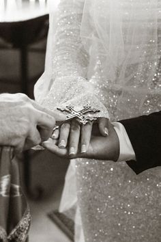 the bride and groom are exchanging their wedding rings